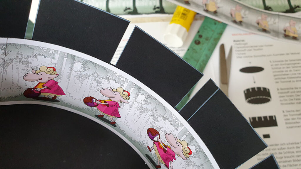 Photo cardboard for making a Zoetrop* with reprinted historical animation strips and with scenes from the new animated film THE SAUSAGE RUN by Thomas Stellmach.