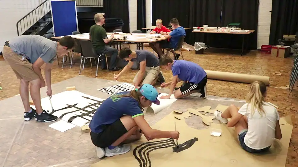 Pixilation-Workshop-2010-making-the-props-960x540 Young participants in a pixilation workshop paint large paper scenery elements for an animated film.